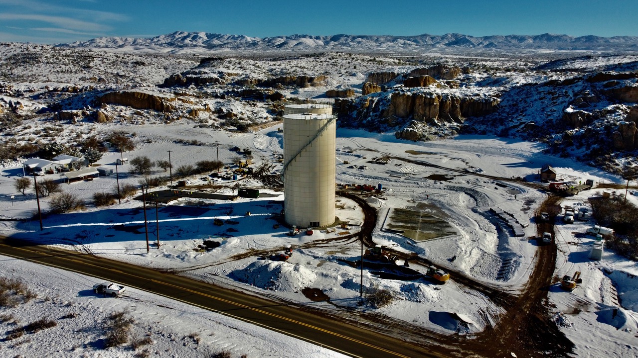 An aerial view of a snow-covered water tower.