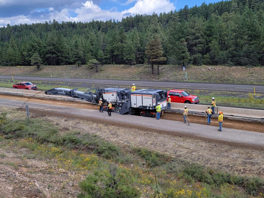 A group of people working on the side of I-17 SB County Line-McConnell Bridge.