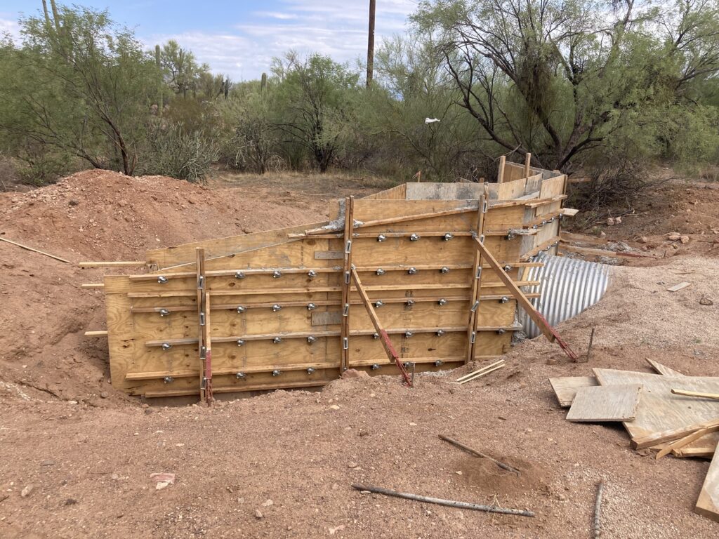 A concrete slab is being built in a dirt area on SR86 Pinal-Pima.