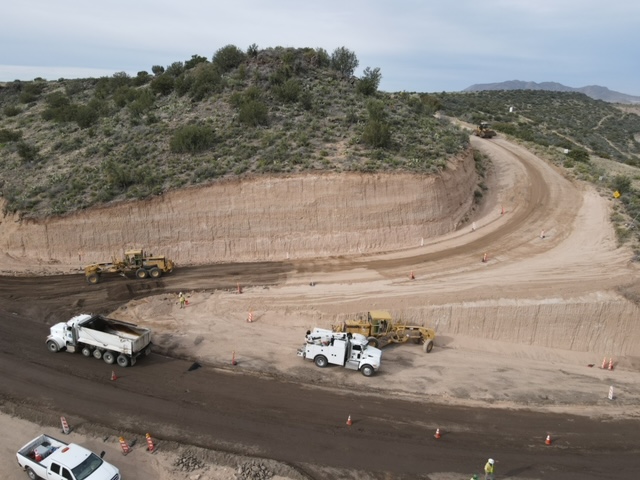 An aerial view of Bagdad Airport Road with trucks on it.