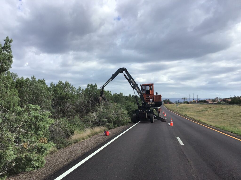 A machine is working on the side of a road.