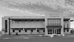 A black and white photo of an office building - About Fann Contracting.