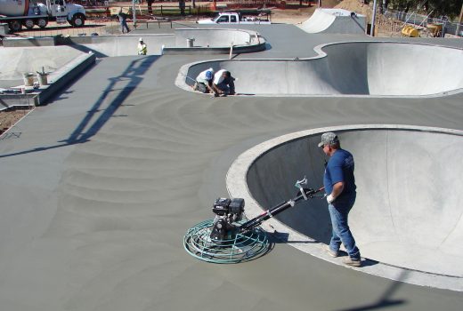 A man spraying concrete at the skatepark in Ken Lindley Park.