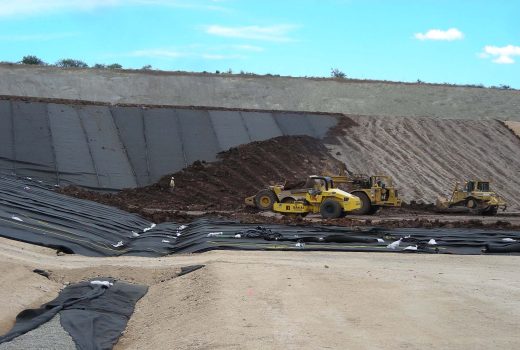 A landfill construction site with a bulldozer.