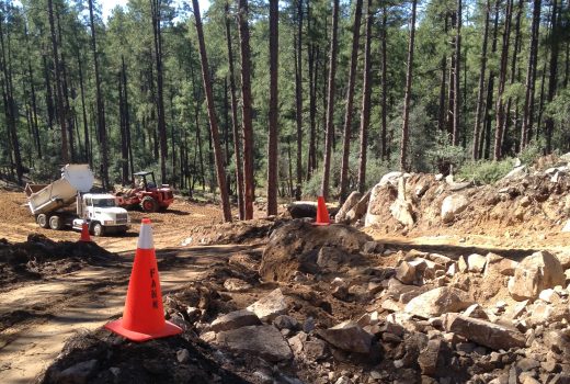 The Goldwater Lake Park Day Use Expansion Project in a forest with orange cones.