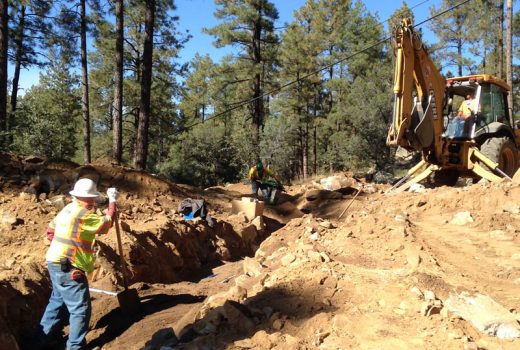 A group of construction workers working on a dirt road as part of the Goldwater Lake Park Day Use Expansion Project.