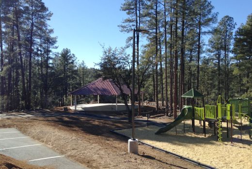 Goldwater Lake Park Day Use Expansion Project with a playground and gazebo in a wooded area.