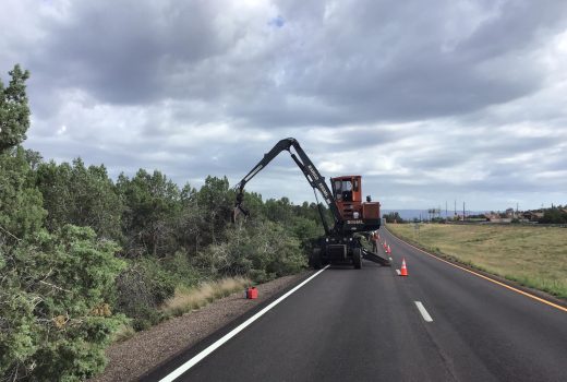 A machine is working on the side of a road.