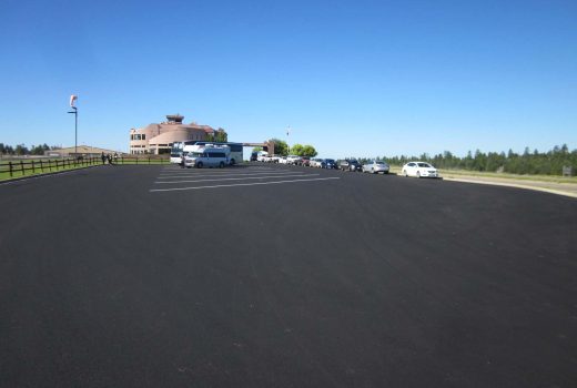 A parking lot with a lot of cars parked in it, featuring Papillon Helicopter flights.