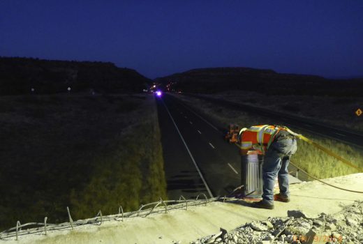 A man working on the side of the road at night on Cordes Jct - Flagstaff Hwy (I-17).