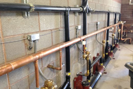 A row of copper pipes and valves in a room at the Ehrenberg Rest Area on I-10.