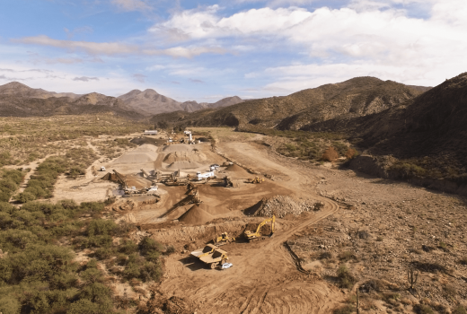 An aerial view of a construction site near Phoenix-Cordes Junction Hwy (I-17) and New River Rd-Coldwater Rd in the desert.