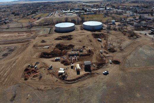 An aerial view of a construction site with oil tanks being developed by GMP 2 (Fann Environmental/Fann Contracting Joint Venture).