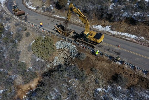 An aerial view of a construction crew working on a road.