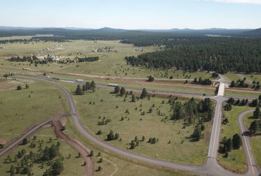 An aerial view of Ash Fork Flagstaff Hwy (I-40) in a forest.