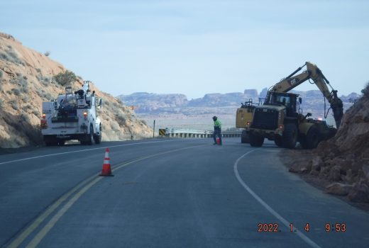 A construction crew is working on a road in the desert.