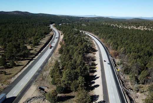 An aerial view of a highway in the forest along the Ash Fork – Flagstaff Highway (I-40).