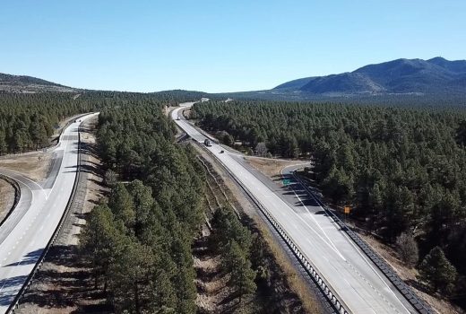 An aerial view of a highway in the mountains near Flagstaff on I-40.