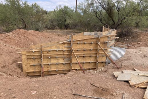 A concrete slab is being built in a dirt area on SR86 Pinal-Pima.