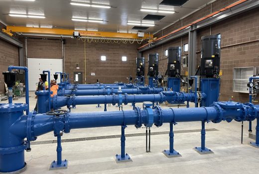 A group of blue pipes in a large room.