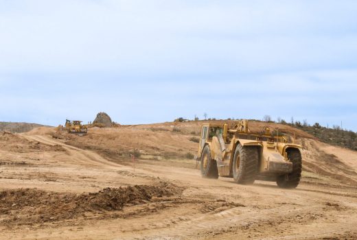 A bulldozer on a dirt road in Granite Dells Estates.