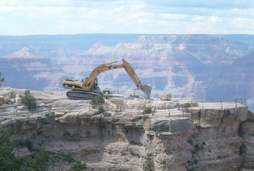 A construction vehicle using contracting methods on a cliff.